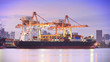 Photo: Container Cargo freight ship with working crane bridge in shipya Container Cargo freight ship with working crane bridge in shipya