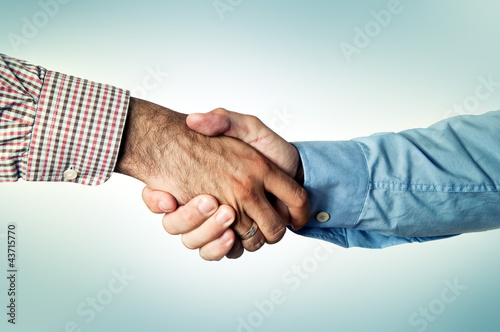 Photo: Two business men shakinh hands Two business men shakinh hands