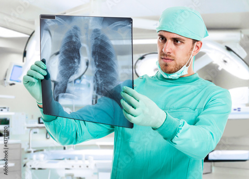 Photo: Surgeon examining a radiography Surgeon examining a radiography