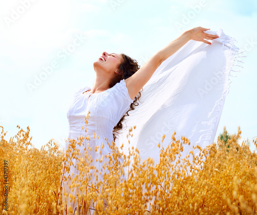 Photo: Beautiful Happy Girl Having Fun on the Wheat Field Beautiful Happy Girl Having Fun on the Wheat Field