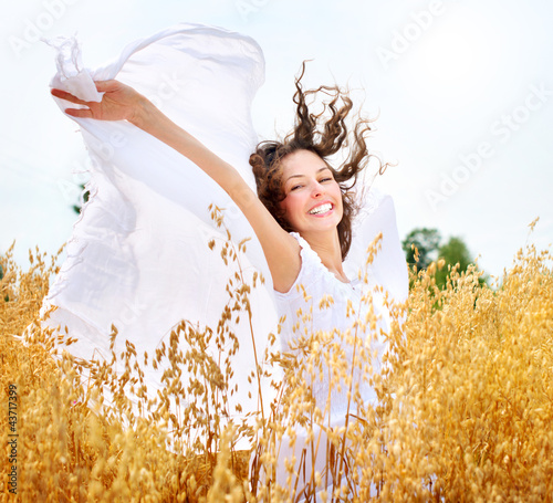 Photo: Beautiful Happy Girl on the Wheat Field Beautiful Happy Girl on the Wheat Field