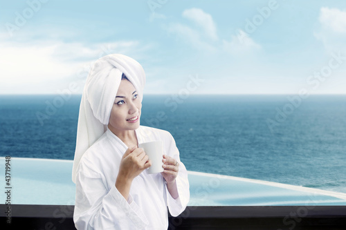 Photo: Woman holding cup of coffee Woman holding cup of coffee