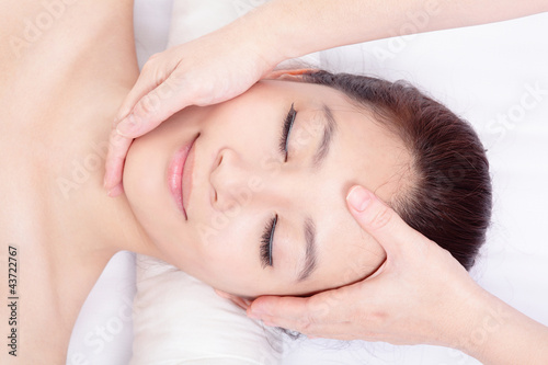 Photo: woman enjoy receiving face and head massage woman enjoy receiving face and head massage