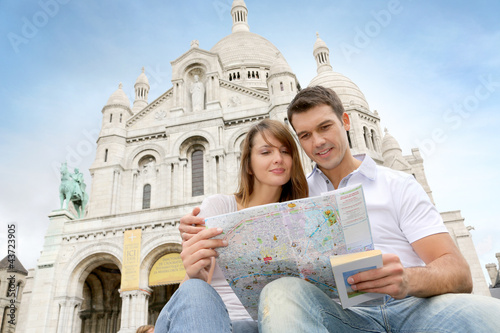 Photo: Couple in Montmartre reading tourist map Couple in Montmartre reading tourist map