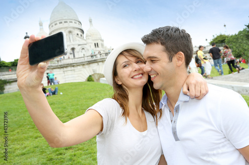 Photo: Lovers taking picture of themselves in front of Sacre Coeur Lovers taking picture of themselves in front of Sacre Coeur