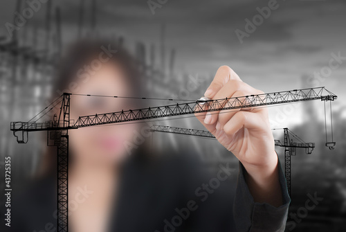 Photo: Business Lady drawing Crane line for Construction concept. Business Lady drawing Crane line for Construction concept.