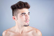 Photo: Young man profile with copyspace on grey background Young man profile with copyspace on grey background