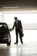 Photo: Businessman walking in underground parking Businessman walking in underground parking