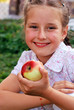 Small girl eating apples