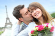 Photo: Man giving flowers to woman in Paris by the Eiffel Tower Man giving flowers to woman in Paris by the Eiffel Tower