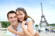 Photo: Man carrying girlfriend on his back in front of Eiffel tower Man carrying girlfriend on his back in front of Eiffel tower