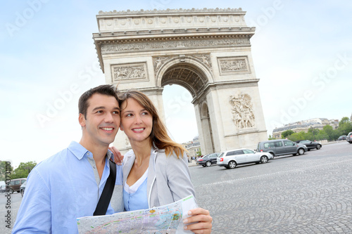 Photo: Couple reading map in front of the Arch of Triumph Couple reading map in front of the Arch of Triumph