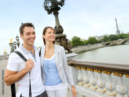 Photo: Couple in Paris walking on the bridge Alexander the Third Couple in Paris walking on the bridge Alexander the Third