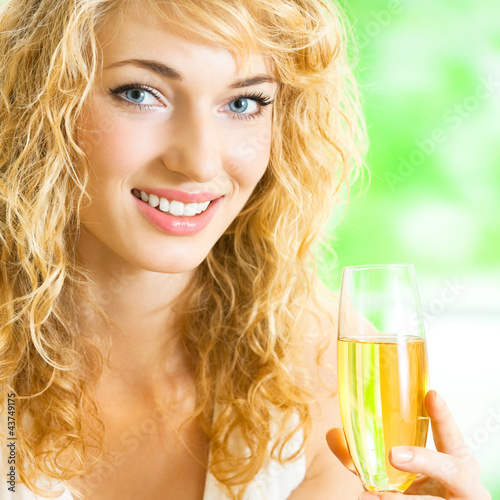 Foto: Young woman with glass of champagne Young woman with glass of champagne