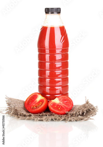 Photo: Tomato juice in bottle on sackcloth isolated on white Tomato juice in bottle on sackcloth isolated on white