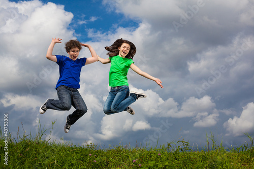 Photo: Girl and boy running, jumping outdoor Girl and boy running, jumping outdoor