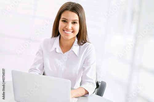 Photo: Business woman working at laptop Business woman working at laptop