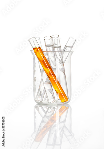 Photo: Chemical flask with a yellow test tubes inside, isolated Chemical flask with a yellow test tubes inside, isolated