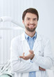 Photo: Smiley dentist welcomes the patient Smiley dentist welcomes the patient