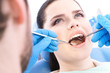 Photo: Dentist examines the teeth of the patient on the dentist's chair Dentist examines the teeth of the patient on the dentist's chair