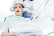Dentist's assistant checks up the teeth of the patient.