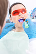 Dentist uses photopolymer lamp to treat carious teeth