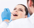Photo: Dentist examines teeth of the patient on the dentist's chair Dentist examines teeth of the patient on the dentist's chair