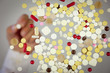 Background of  Pills and Hand holding a Pill