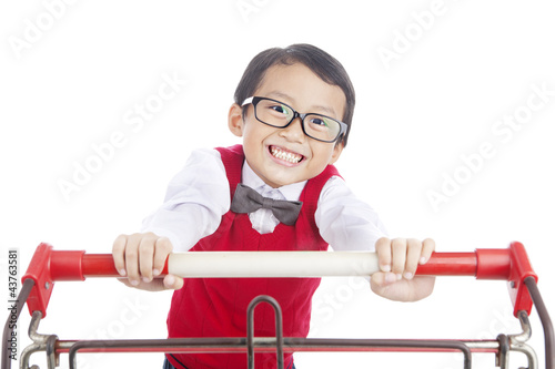 Photo: School child pushing trolley School child pushing trolley
