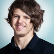 Closeup portrait of a young smiling man with curly hai