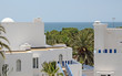Beautiful view of sea, horizon, palms and white buildings