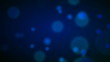 Blue particle bokeh background.