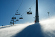 backlit scenes with ski lift chairs