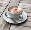 Cup of Cappuccino on wooden slat table