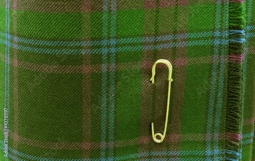 Photo: Kilt vert et épingle. Kilt vert et épingle.