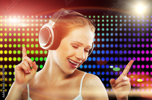Photo: Portrait of a young dancing girl in headphones Portrait of a young dancing girl in headphones