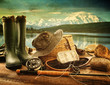 Fly fishing equipment on deck with view of a lake and mountains
