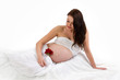 Beautiful pregnant brunette lady on white background