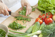 Cook in the kitchen at work preparing vegetable salad