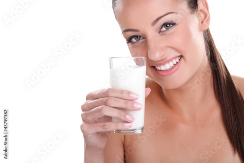 Photo: Happy and smiling beautiful young woman with glass milk. Happy and smiling beautiful young woman with glass milk.