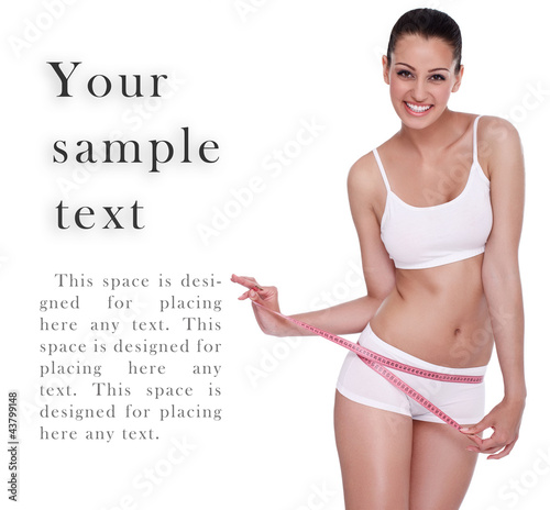 Photo: excited woman standing with measuring tape excited woman standing with measuring tape