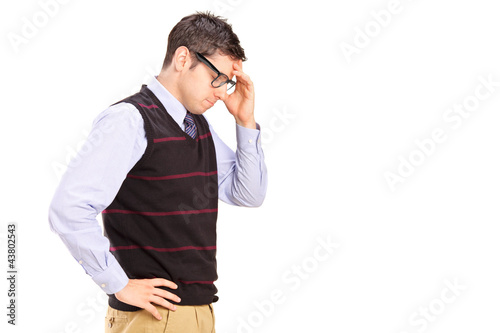 Photo: A young male with head down thinking A young male with head down thinking