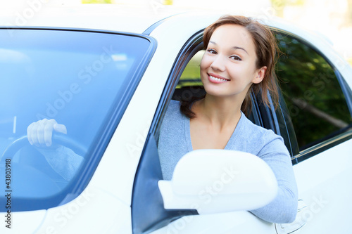 Photo: Pretty girl in a car smiling to you Pretty girl in a car smiling to you