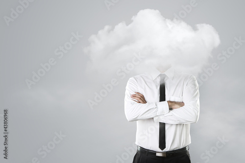Foto: Young businessman with head in the clouds Young businessman with head in the clouds