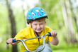 Portrait of a cute kid on bicycle