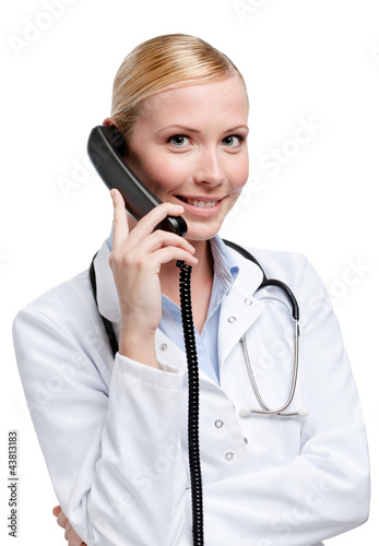Photo: Doctor makes a phone call, isolated on white Doctor makes a phone call, isolated on white
