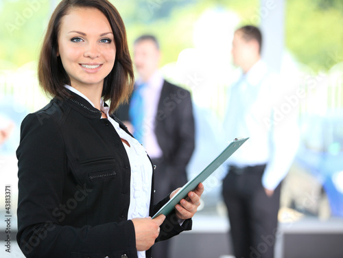 Photo: Face of beautiful woman on the background of business people Face of beautiful woman on the background of business people