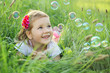 Foto: Happy little girl playing with bubbles Happy little girl playing with bubbles