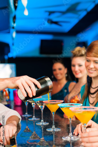 Photo: People in club or bar drinking cocktails People in club or bar drinking cocktails