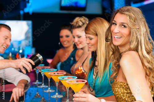 Photo: People in club or bar drinking cocktails People in club or bar drinking cocktails